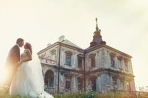 two couple after wedding in tne park near the castle